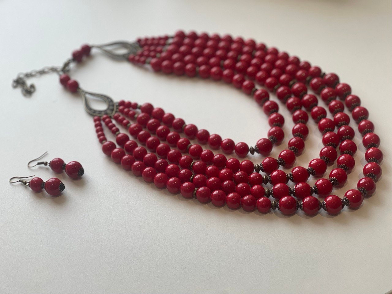 Red handmade Ukrainian necklace with pressed coral beads, traditional ethnic Hutsul jewelry, paired with matching earrings.
