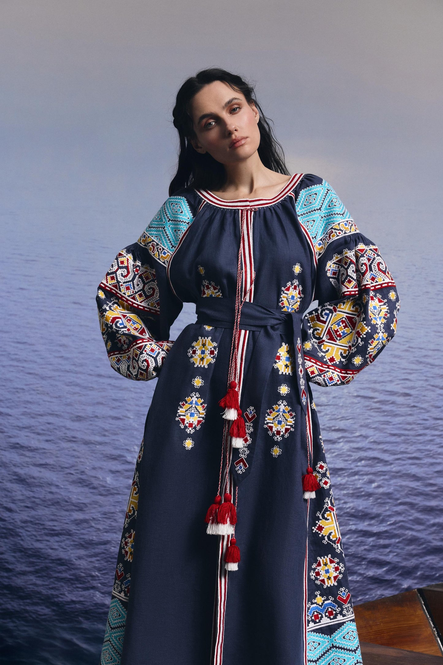 Woman wearing a blue linen embroidered wedding dress styled as Ukrainian vyshyvanka with boho Mexicana influences.