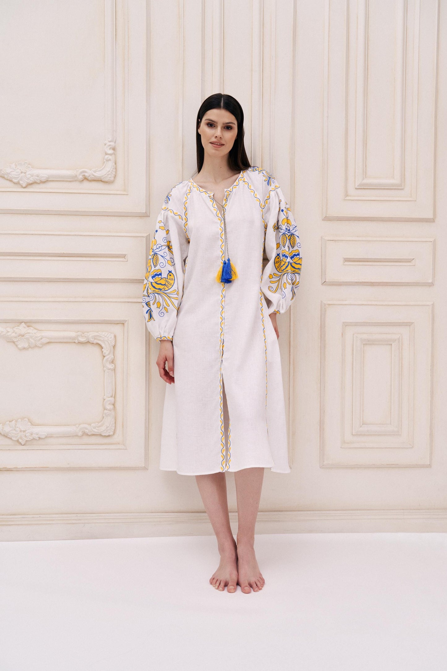 White linen Ukrainian Vyshyvanka wedding dress with embroidery worn by model.