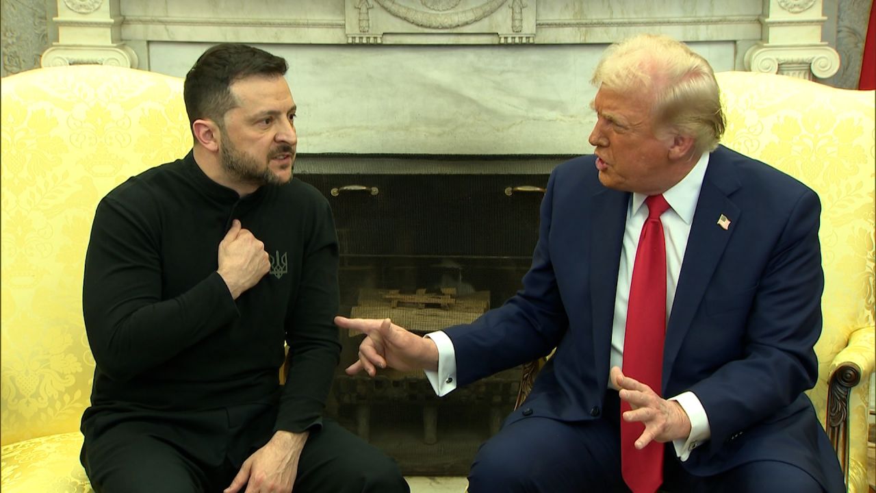Two leaders engaged in a serious discussion seated in a formal room.