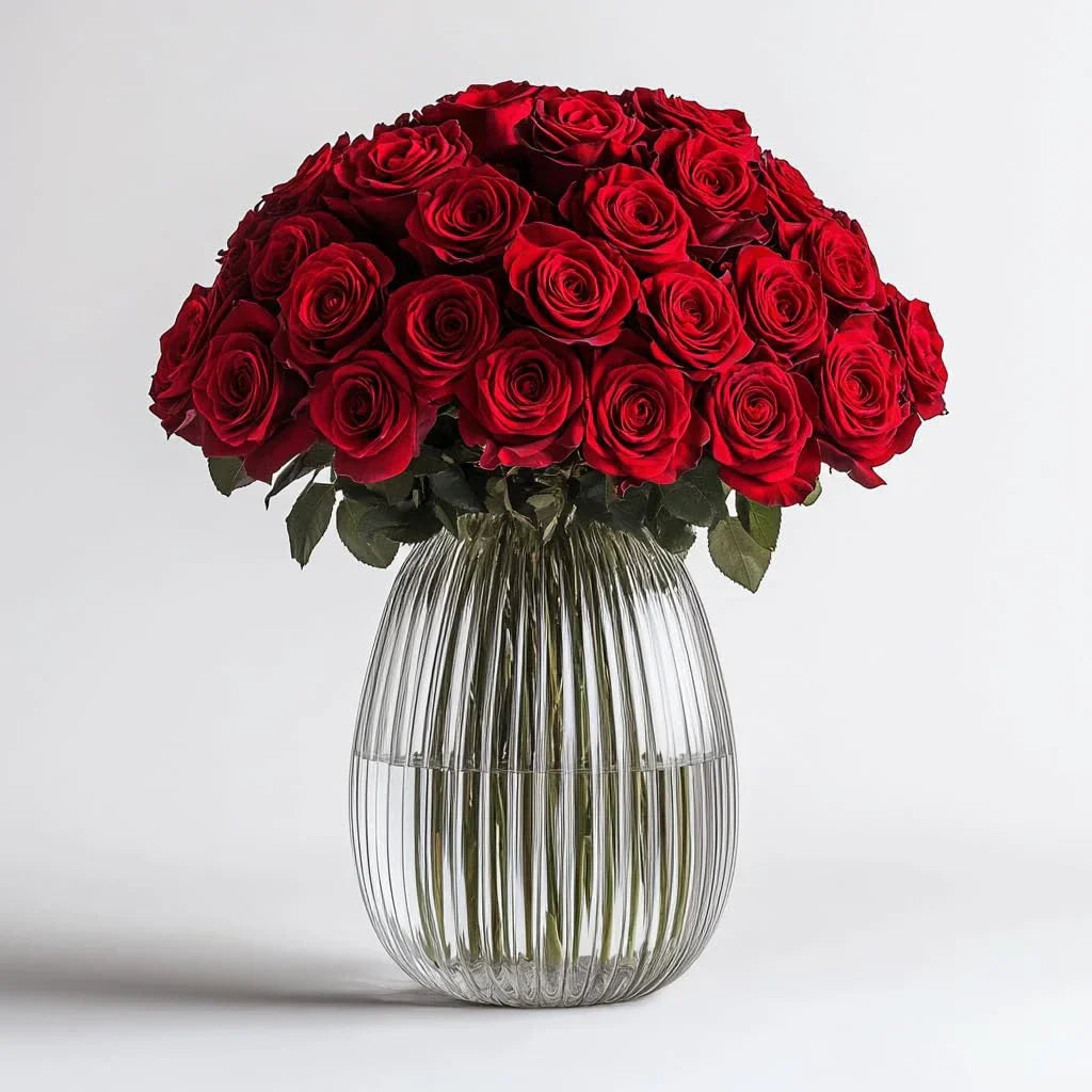 Elegant bouquet of red roses in a clear glass vase, perfect for romantic gifts and special occasions.