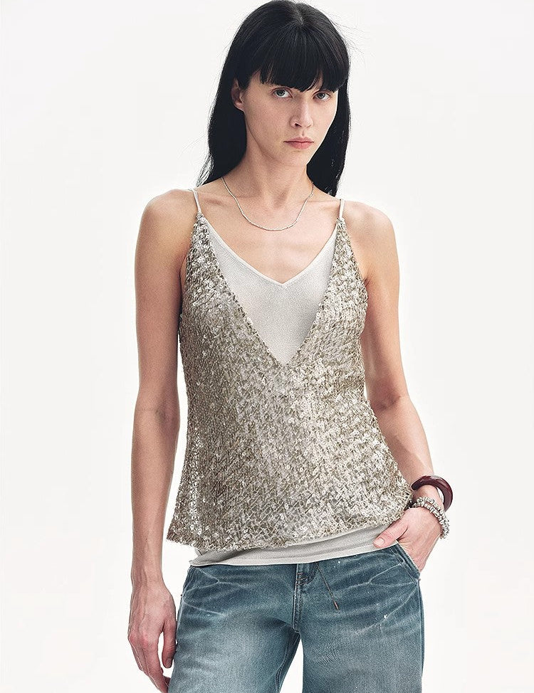 Sleeveless silver sequin top with deep V-neckline worn by model, paired with jeans, showcasing a boho-chic look.