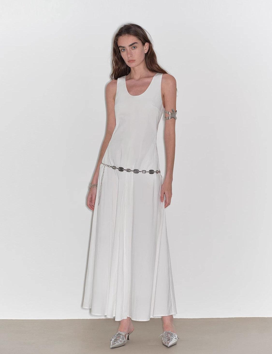Woman wearing Lakelyn U-Neck A-Line Vest Dress with a sleeveless design and flowy skirt in white high-density cotton brocade fabric.