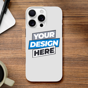 Glossy print on demand iPhone case with customizable design on a wooden table, next to a pen and coffee cup.