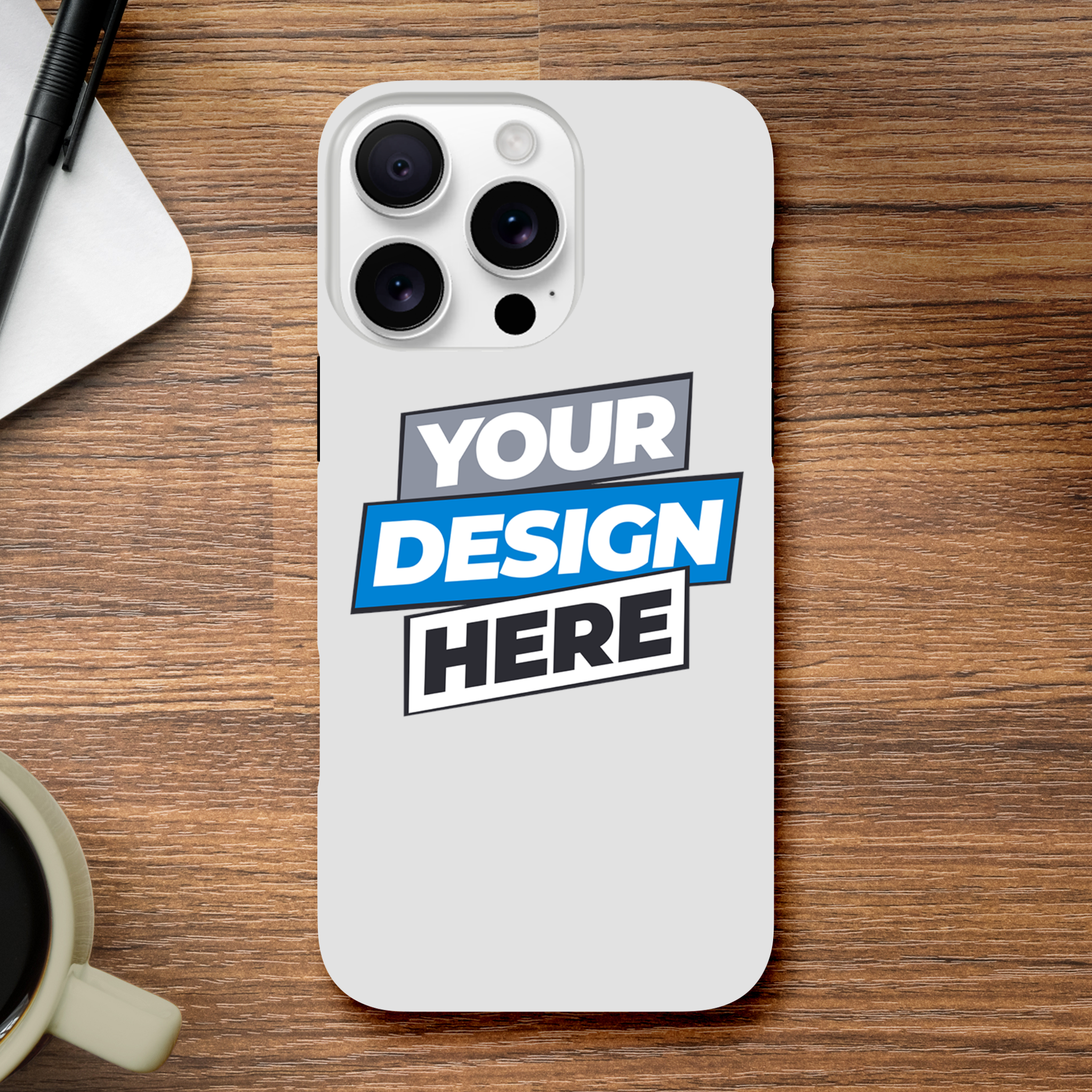 Glossy print on demand iPhone case with customizable design on a wooden table, next to a pen and coffee cup.