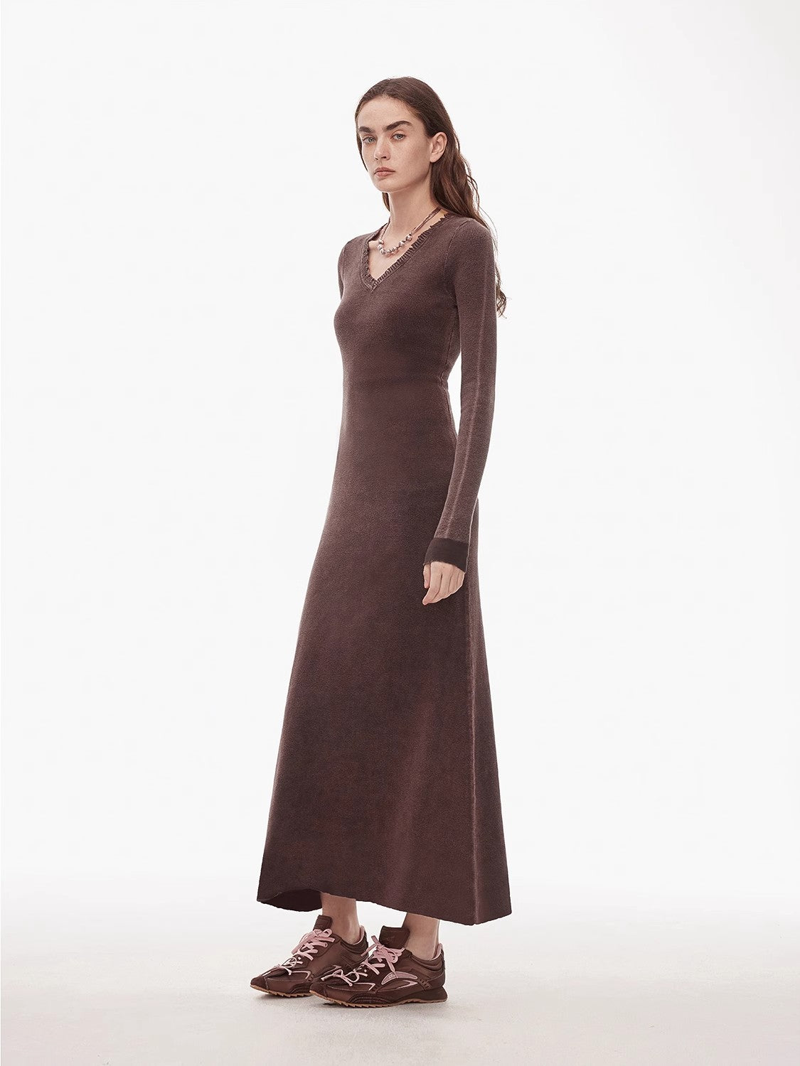 Selvara distressed cotton V-neck dress with raw-cut edges and contrast cuffs, showcasing a relaxed and vintage style.