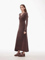 Selvara distressed cotton V-neck dress with raw-cut edges and contrast cuffs, showcasing a relaxed and vintage style.