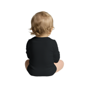 Baby wearing a black Serano Long Sleeve Bodysuit, sitting from the back, showcasing soft cotton fabric and lap shoulder design.