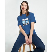 Woman wearing a blue Zalmera cotton t-shirt with customizable print design, seated on a stool, showcasing casual style.
