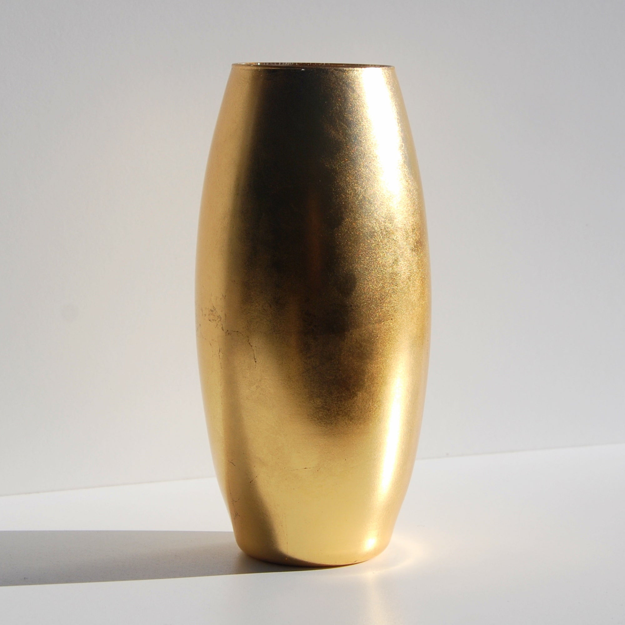 Gilt gold leaf oval glass vase with a radiant finish, ideal for tall floral arrangements or as a standalone decor piece.