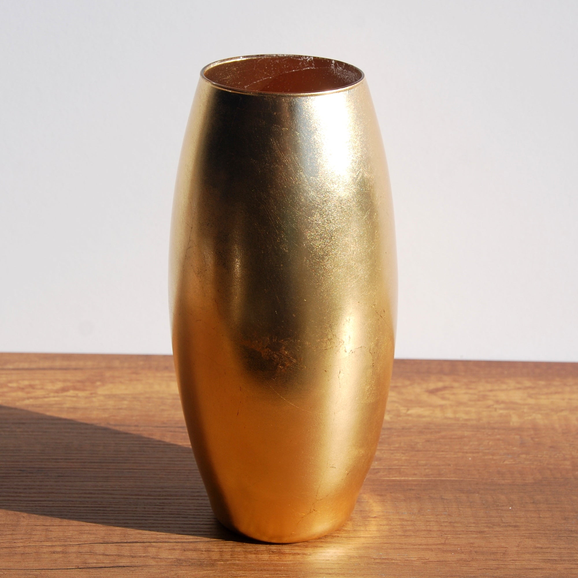 Gilt gold leaf oval glass vase with distressed finish, 10 inches tall, ideal for floral arrangements or as a decorative object.