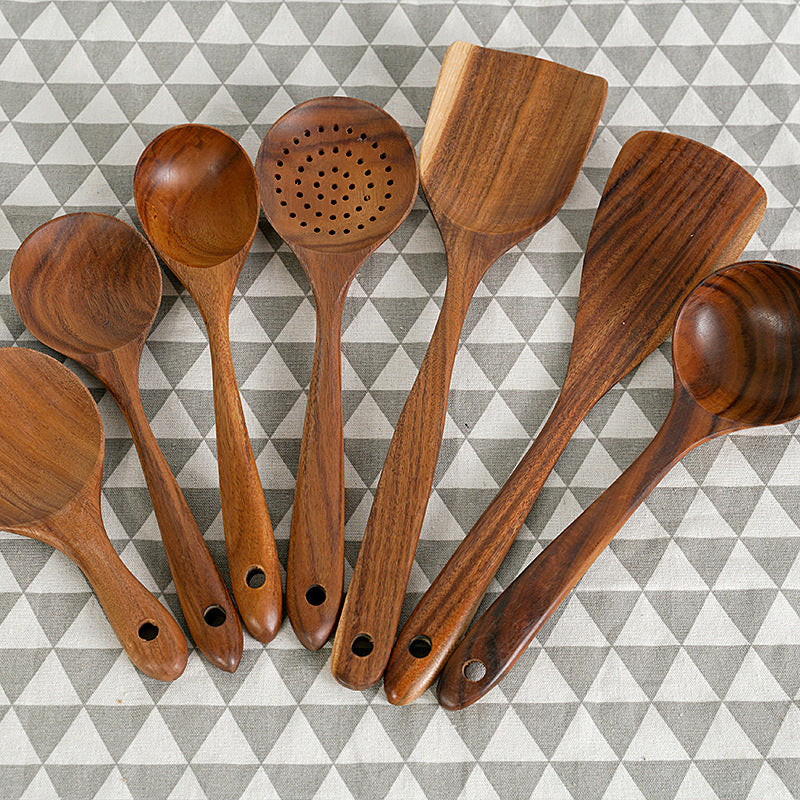 Teak unlacquered solid wood spatulas for non-stick cookware, ideal for stir-fry, set of seven, displayed on patterned background.