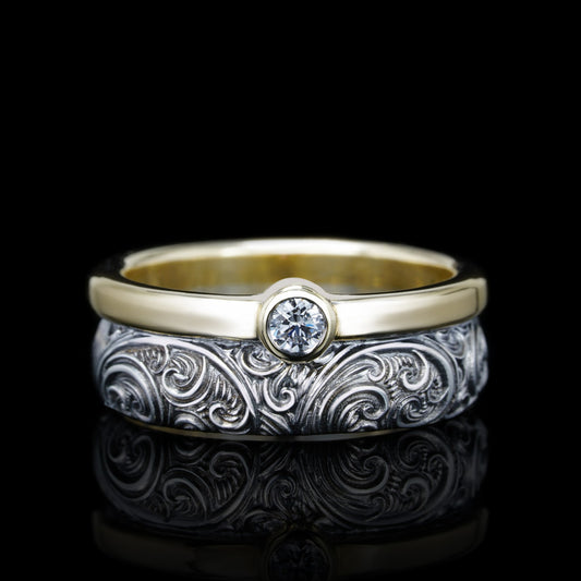 "Endless Flame wedding ring in sterling silver and 14K gold with a central 3mm diamond and intricate black rhodium pattern"