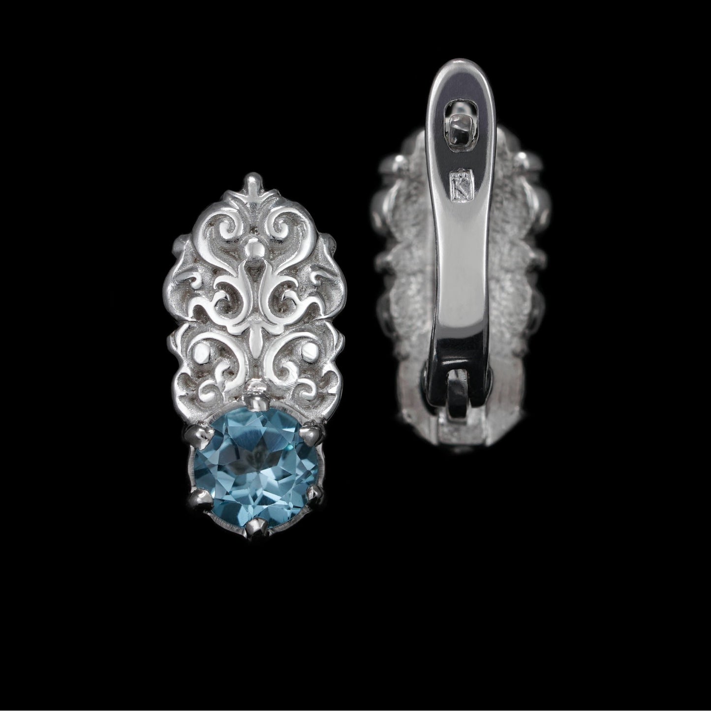 Regal Grace earrings in sterling silver with topaz gemstones, elegant and handcrafted with white rhodium plating, on a black background.