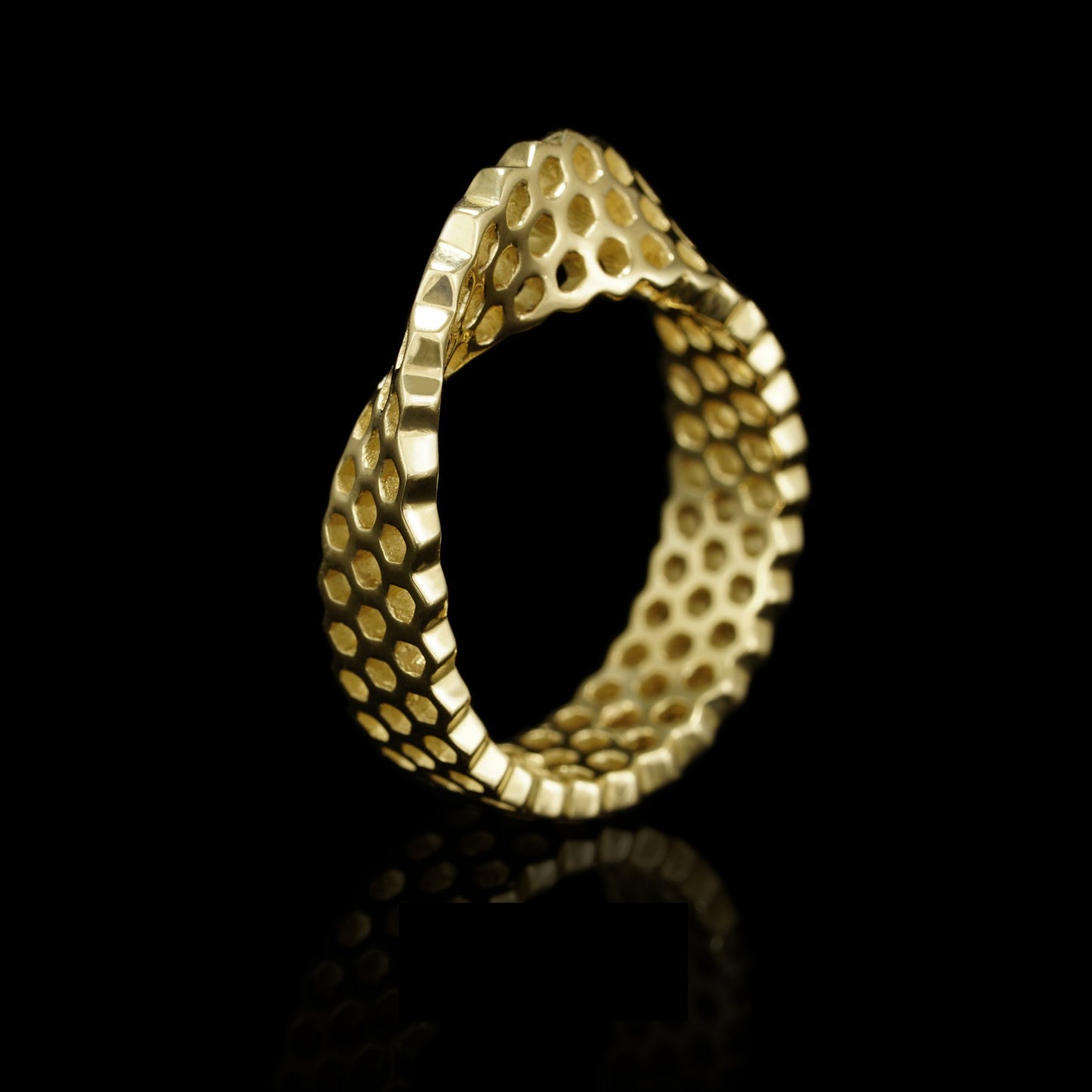 Gold Mobius-shaped "Eternal Ribbon" ring crafted from 14K yellow gold, representing timeless connections and unity.