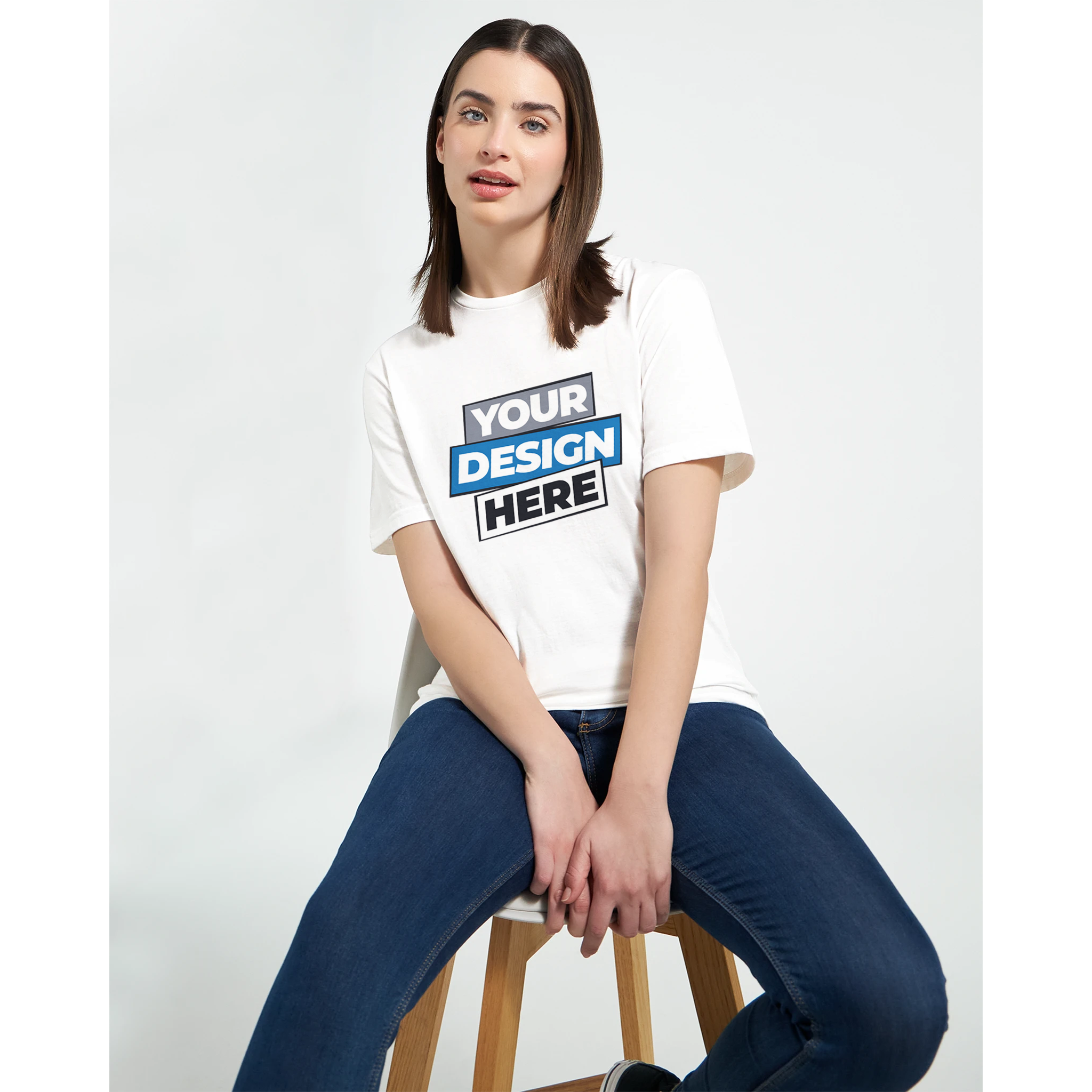 Woman wearing Zalmera cotton t-shirt with customizable print design, sitting on stool.