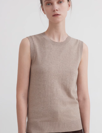 Woman wearing a Noriven Cottonwool Sweater Vest featuring a sleeveless, light brown design with a rounded neckline and clean lines.