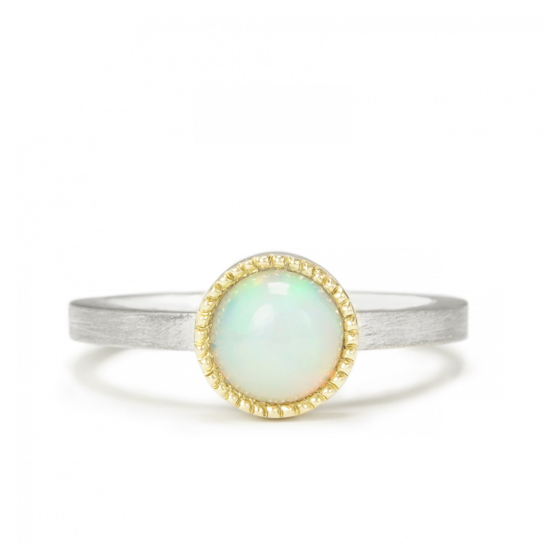 Cosmic Horizon ring with opal stone set in sterling silver and gold, showcasing celestial-inspired design and shimmer.