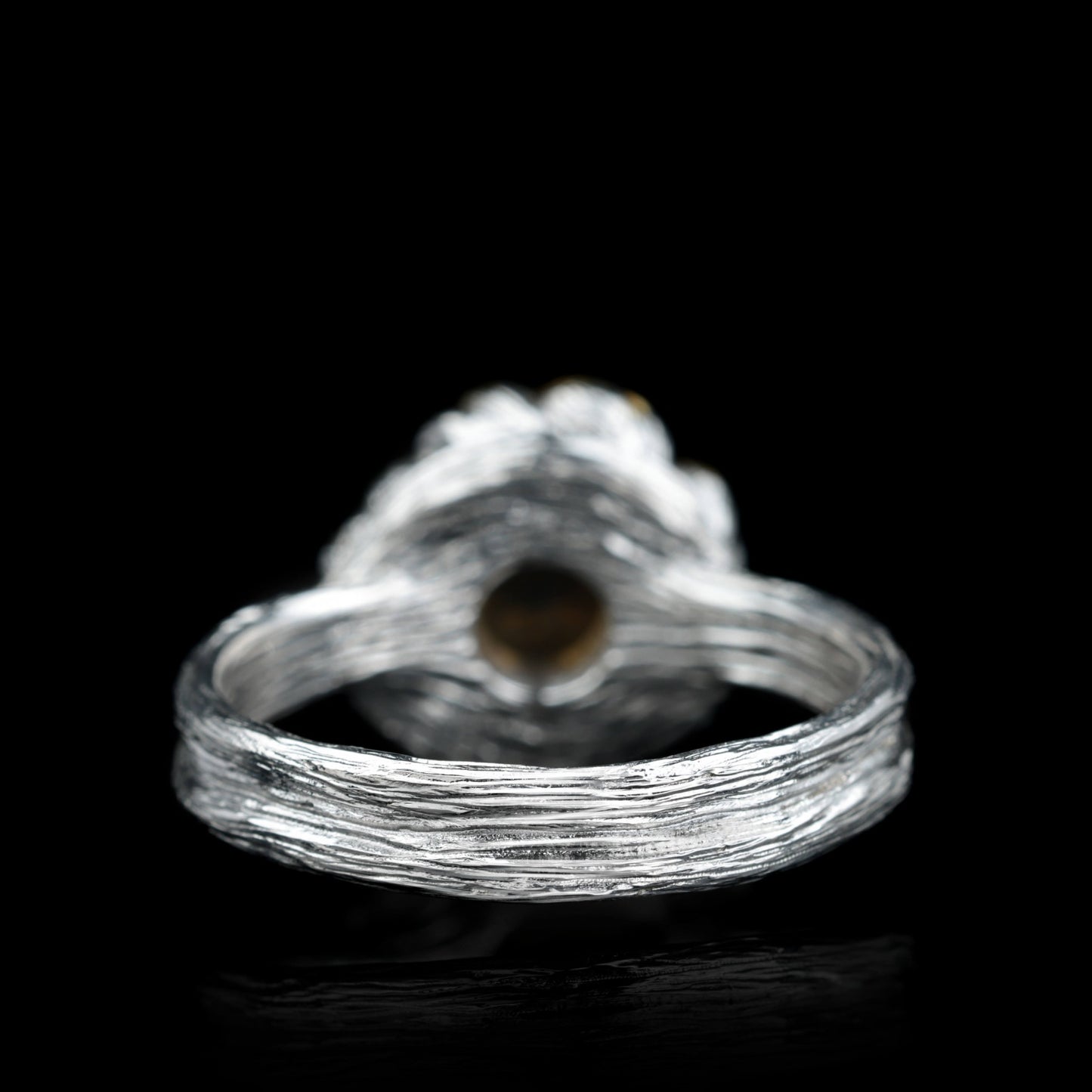 Sterling silver "Golden Blossom" ring with citrine, inspired by blooming peony, showcasing textured band on black background.