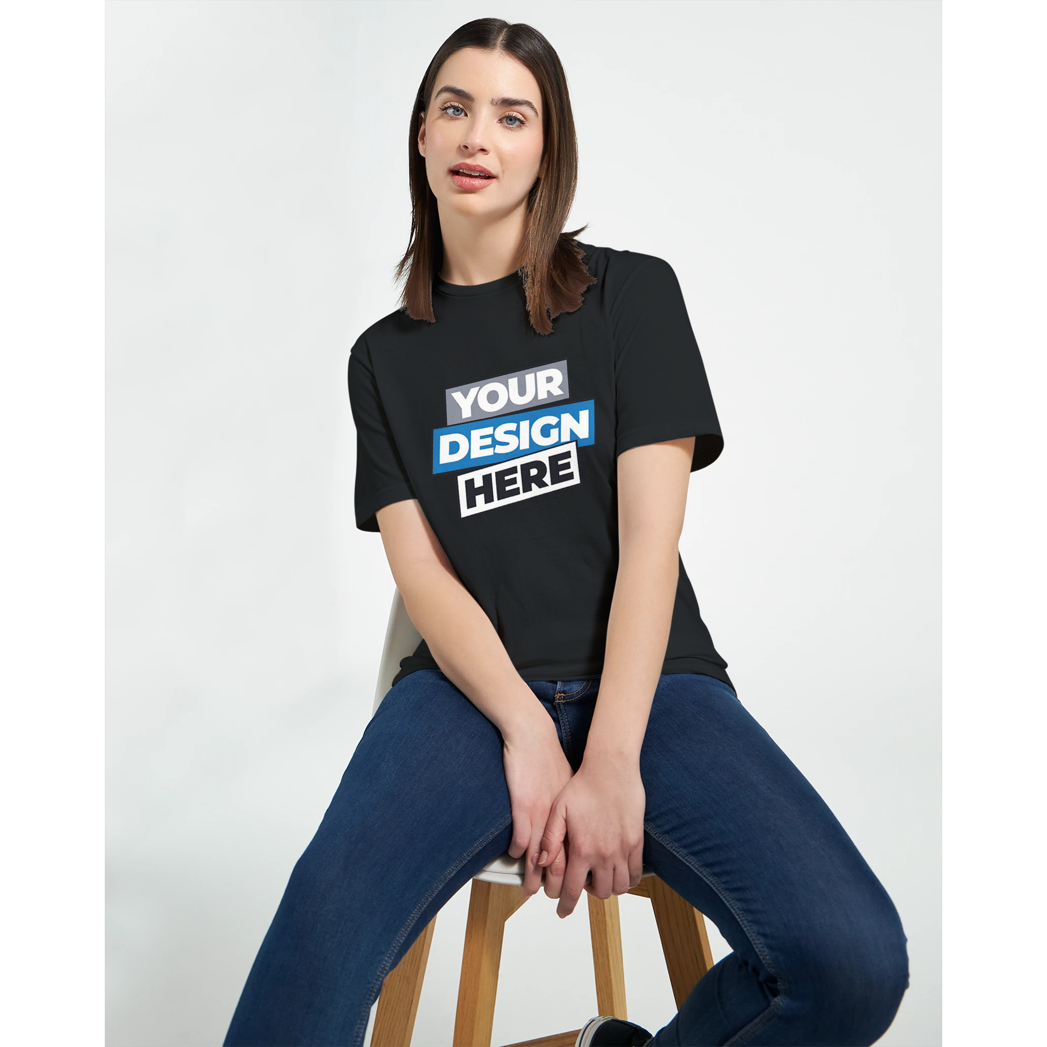 Woman wearing Print on Demand Zalmera Women’s Cotton T-Shirt with customizable design, sitting on a stool.