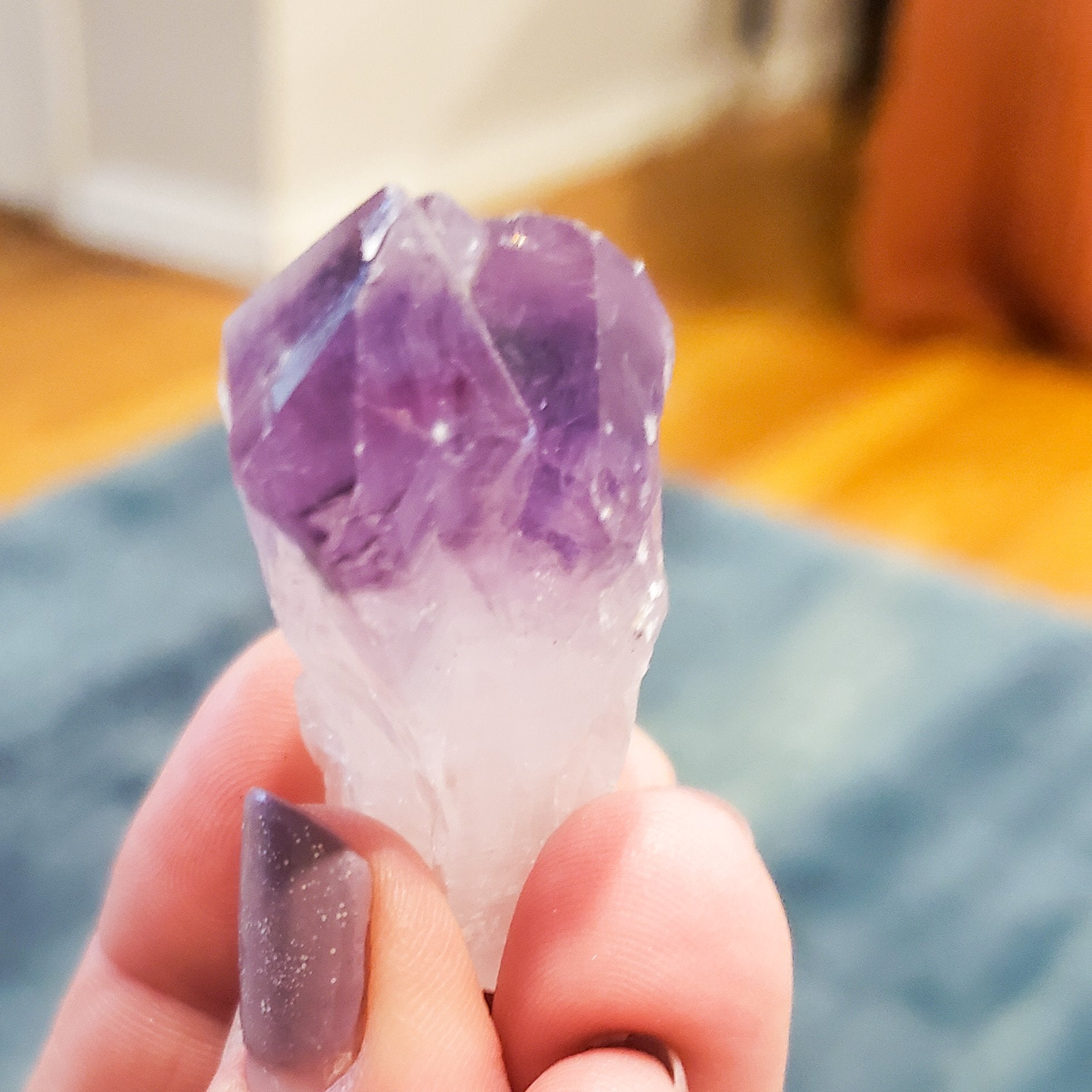 Hand holding a pocket-sized Moonlit Amethyst Rough Stone for meditation, enhancing intuition and reducing stress with calm energy.