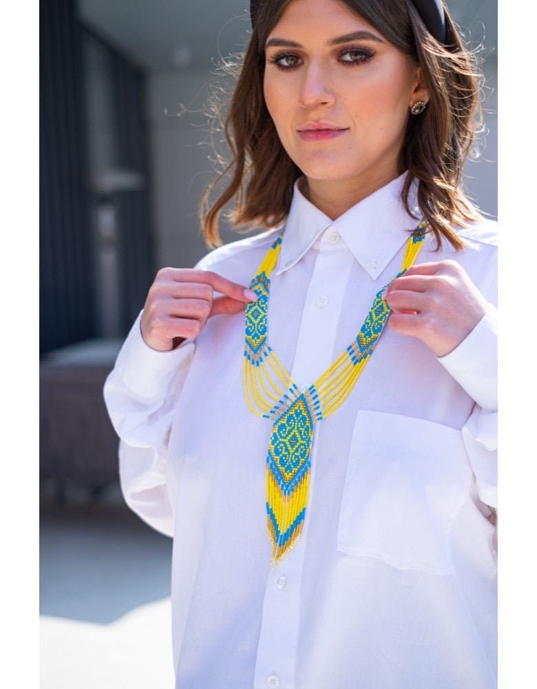 Woman wearing 2025 handmade Ukrainian gerdan necklace in yellow and blue, representing cultural pride and heritage.