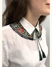 Woman wearing handmade Ukrainian Kryza green beaded Vyshyvanka necklace, traditional folk-style collar with intricate patterns.