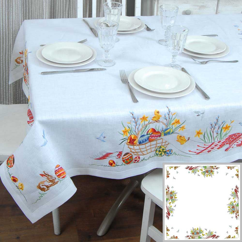 Elegant 2025 linen embroidered tablecloth for Ukrainian Easter, 140×140 cm, featuring festive floral and bunny designs on a dining table.