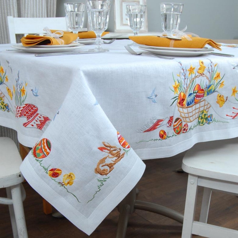 Linen embroidered tablecloth with Ukrainian Easter design, 140x140 cm, featuring festive patterns and decor on a dining table.