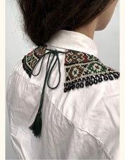 Back view of person wearing Ukrainian green beaded Kryza necklace with traditional patterns