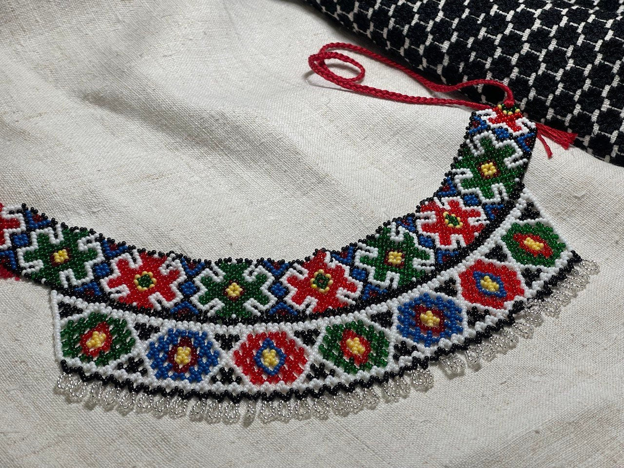 Handmade Ukrainian Sylyanka necklace crafted with Czech seed beads featuring vibrant geometric and floral motifs.