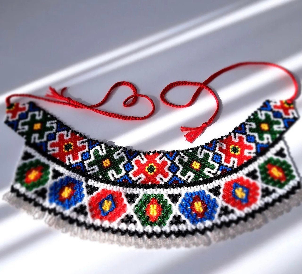 Handmade Ukrainian Sylyanka necklace with vibrant geometric and floral patterns using Czech seed beads.