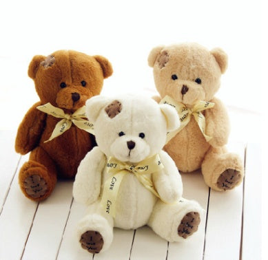 Trio of cute teddy bear plush toys with patch designs, featuring high-quality PP cotton and ribbon bows, ideal for gifts.