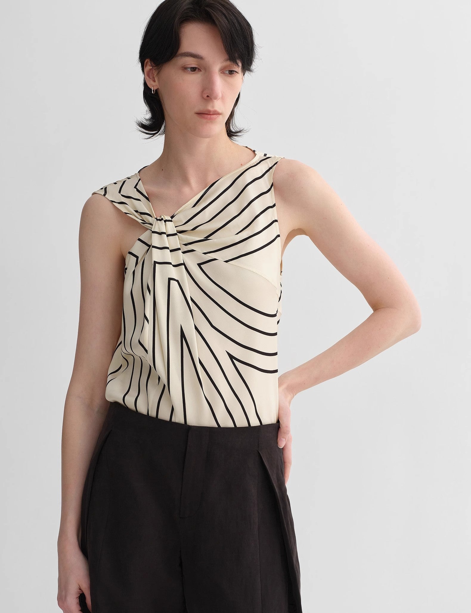 Model wearing Seravelle Twisted Silk Vest with asymmetrical design and geometric print, blending minimalism and elegance.