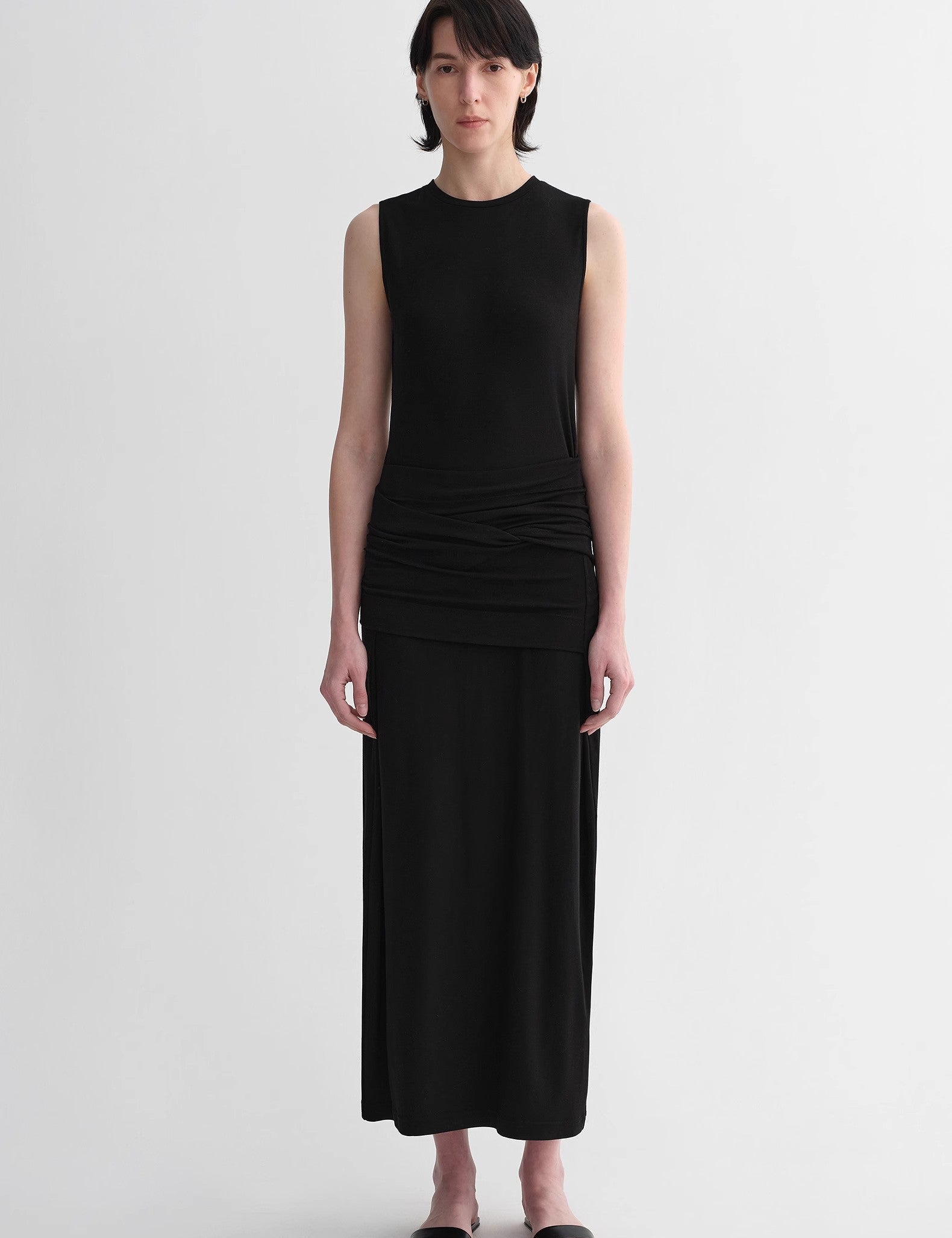 Woman wearing Urban Sculpt Wool Blend Midi Dress with round neckline and tailored armholes, showcasing minimalist design and elegance.