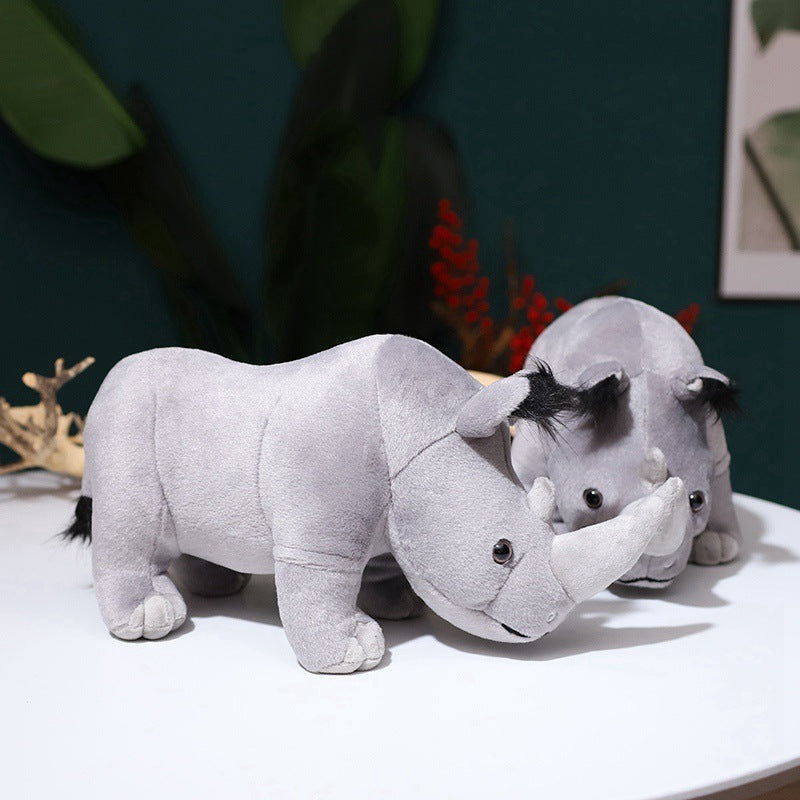 Cute rhino shape plush toys on a table, made from soft fabric and filled with PP cotton, perfect gift for teenagers and animal lovers.