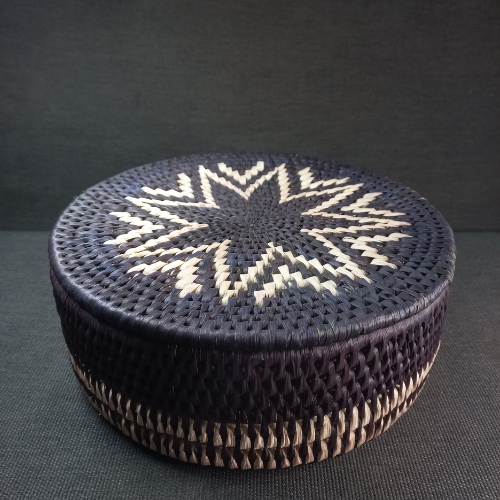 Norya Handwoven Basket made from natural palm leaf with intricate pattern and lid, showcasing artisan craftsmanship and timeless charm.