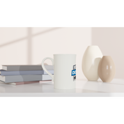 Slim white porcelain mug 10oz with custom print on a minimalist countertop beside books and ceramic vases.