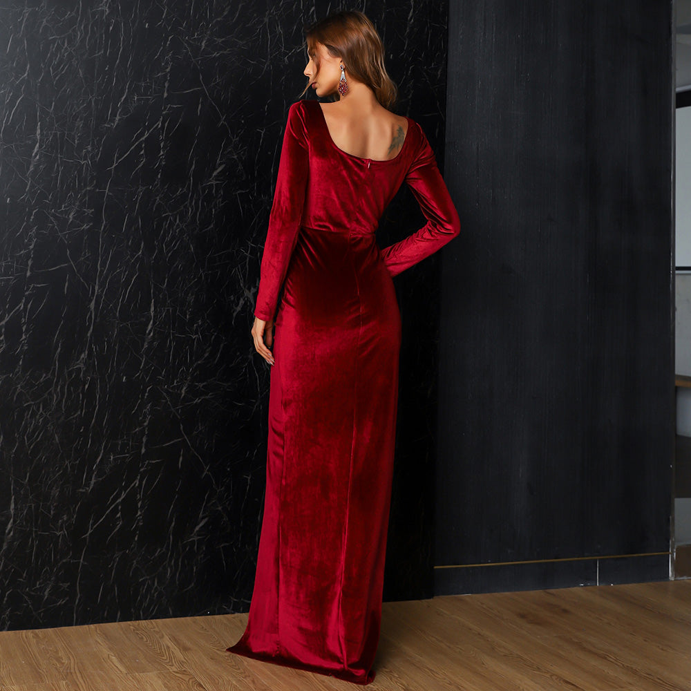Elegant red velvet floor-length gown with long sleeves, showcasing luxurious texture and flattering silhouette, perfect for formal occasions.