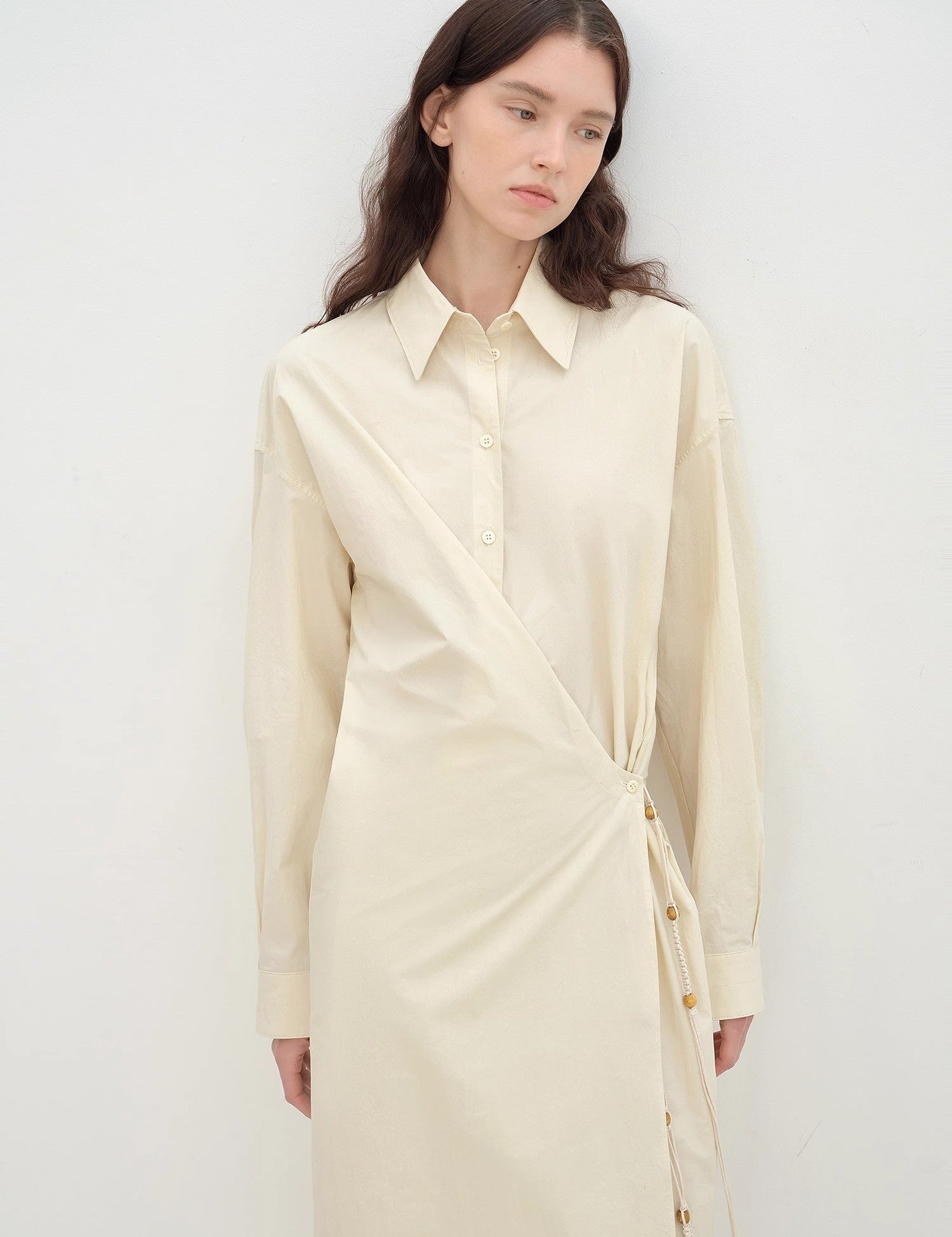 Model wearing Whisper Wrap Cotton Shirt Dress with lapel collar and cross-placket, showcasing a minimalist, relaxed cocoon silhouette.