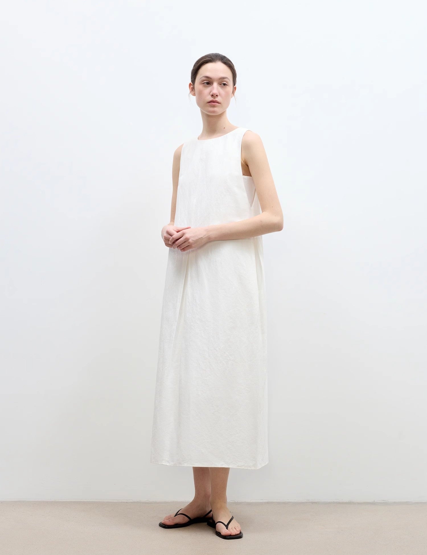 Model wearing a white Serelis Cotton-Linen Hourglass Dress with a gentle U-neck, tailored waist, and A-line skirt for elegant style.