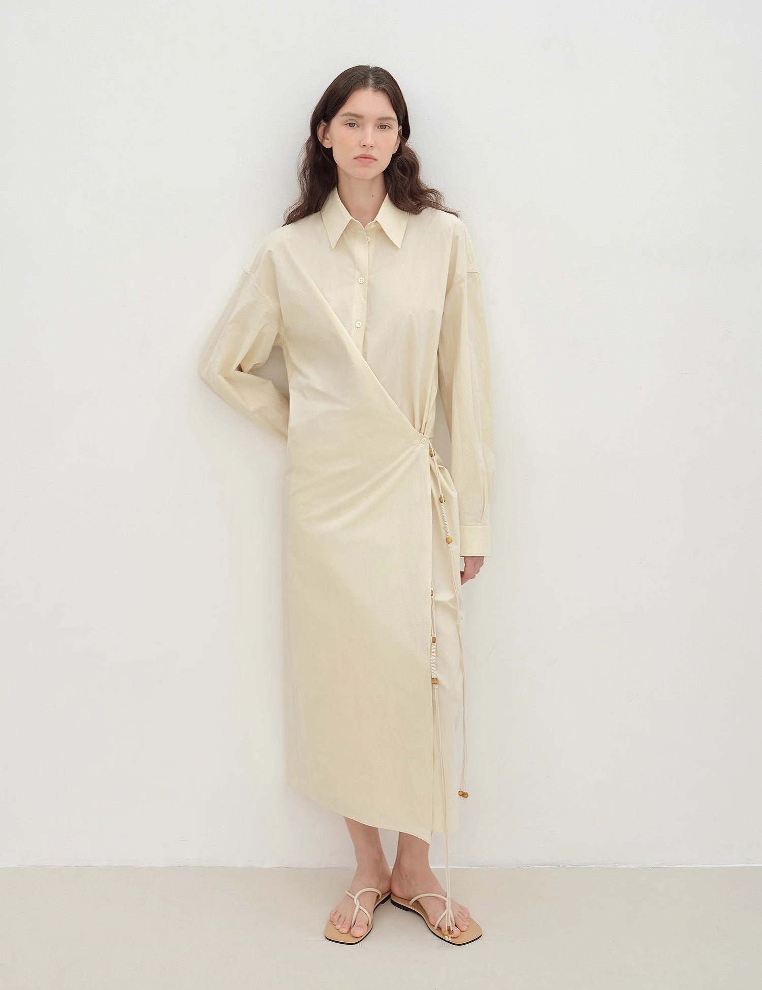 Model wearing Whisper Wrap Cotton Shirt Dress with lapel collar and cross-placket closure, showcasing relaxed, elegant design in soft cotton.