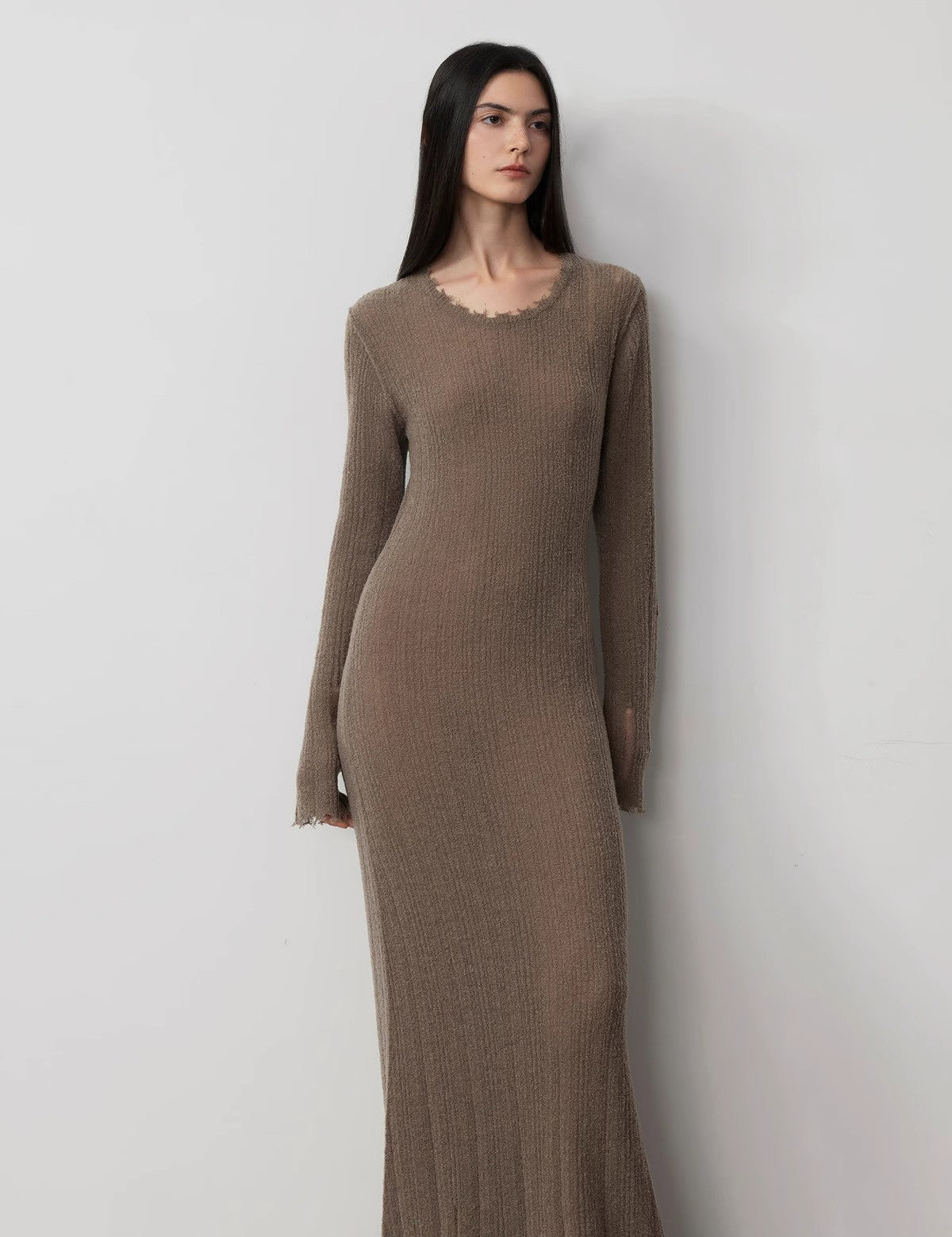 Woman wearing Fray Line Wool Knit Dress with edgy frayed edges and subtle cut-outs for a contemporary sculptural look.