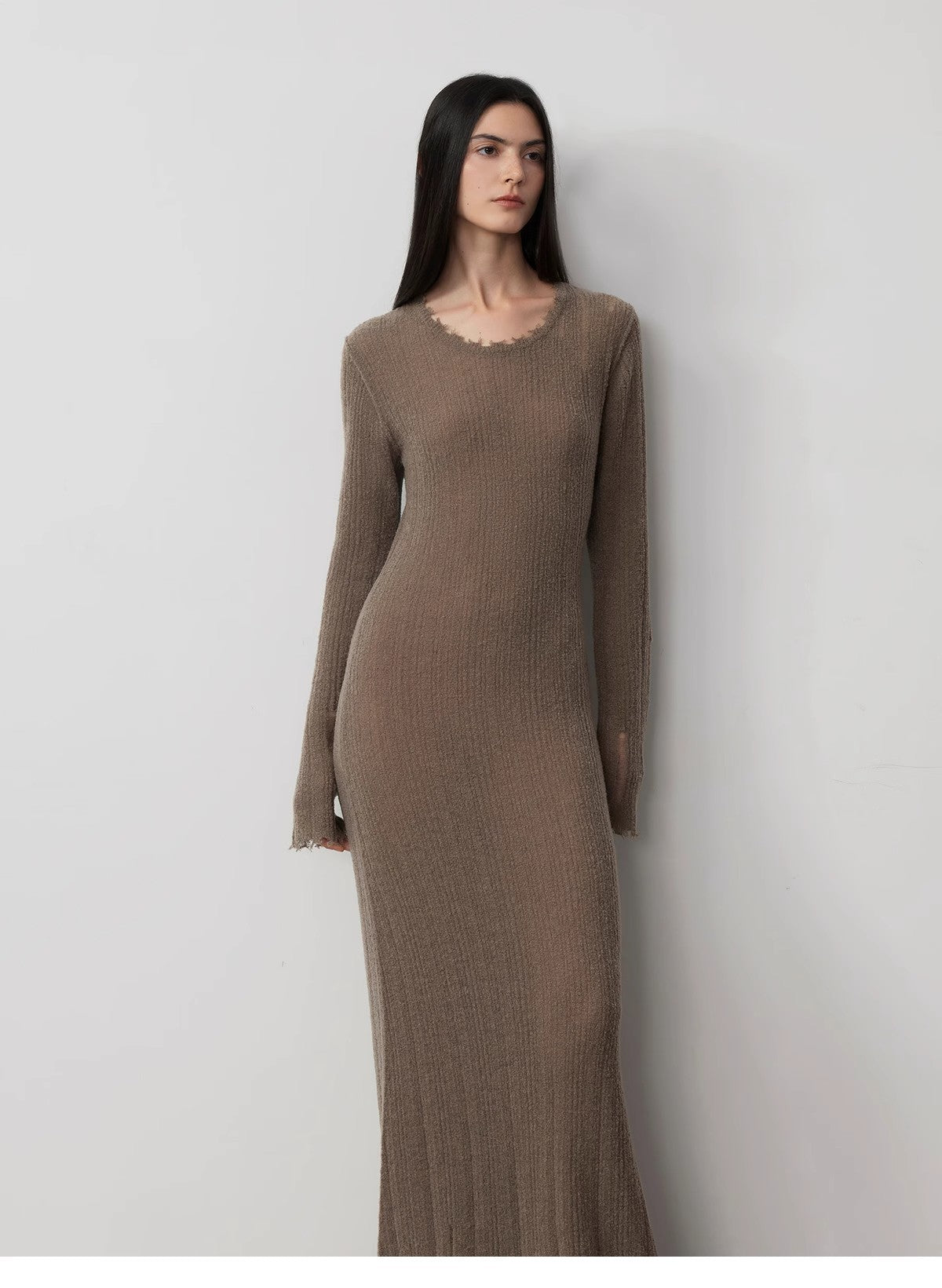 Woman wearing Fray Line Wool Knit Dress with edgy frayed edges and subtle cut-outs for a contemporary sculptural look.