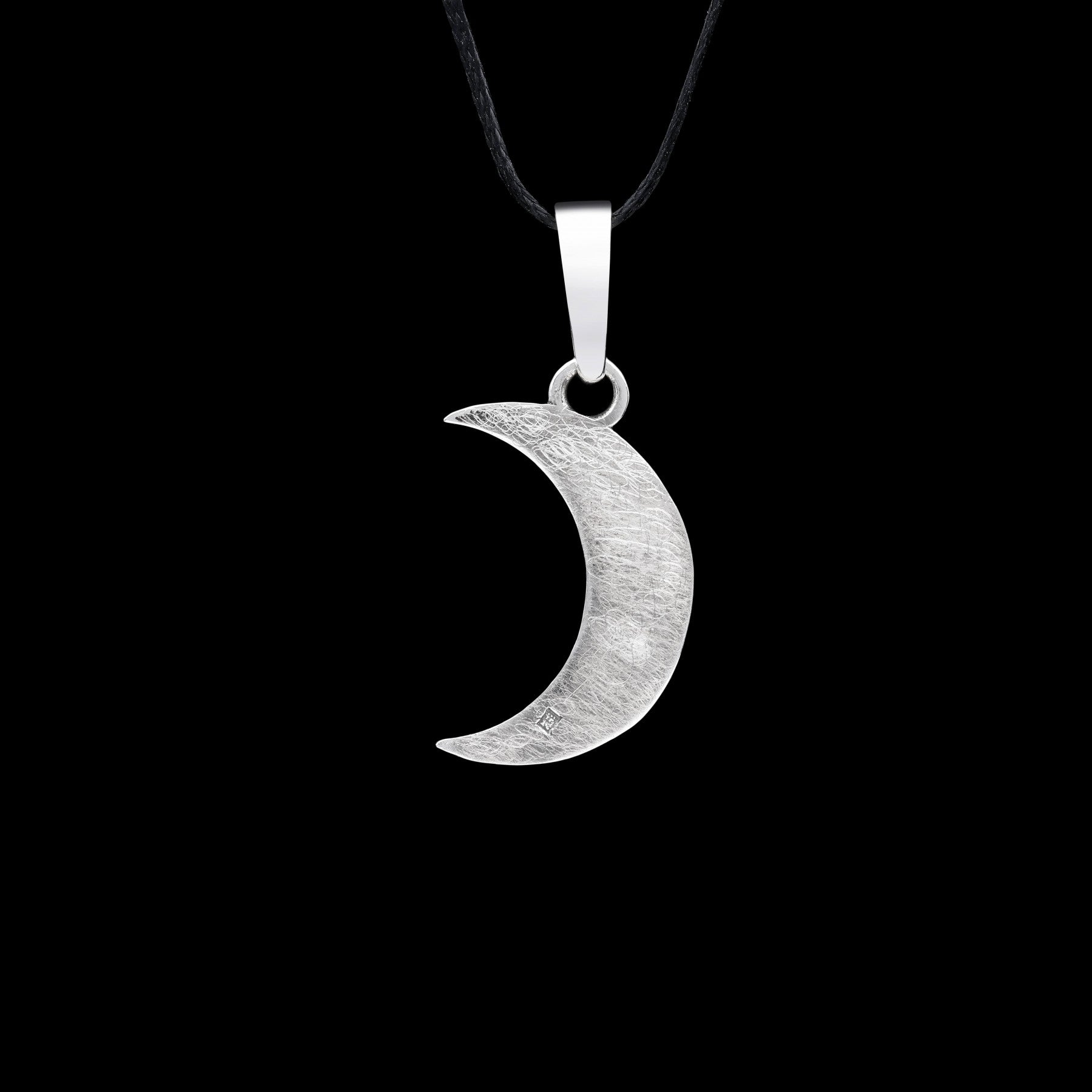 Sterling silver crescent moon pendant with oxidized finish on black background, featuring elegant celestial design.