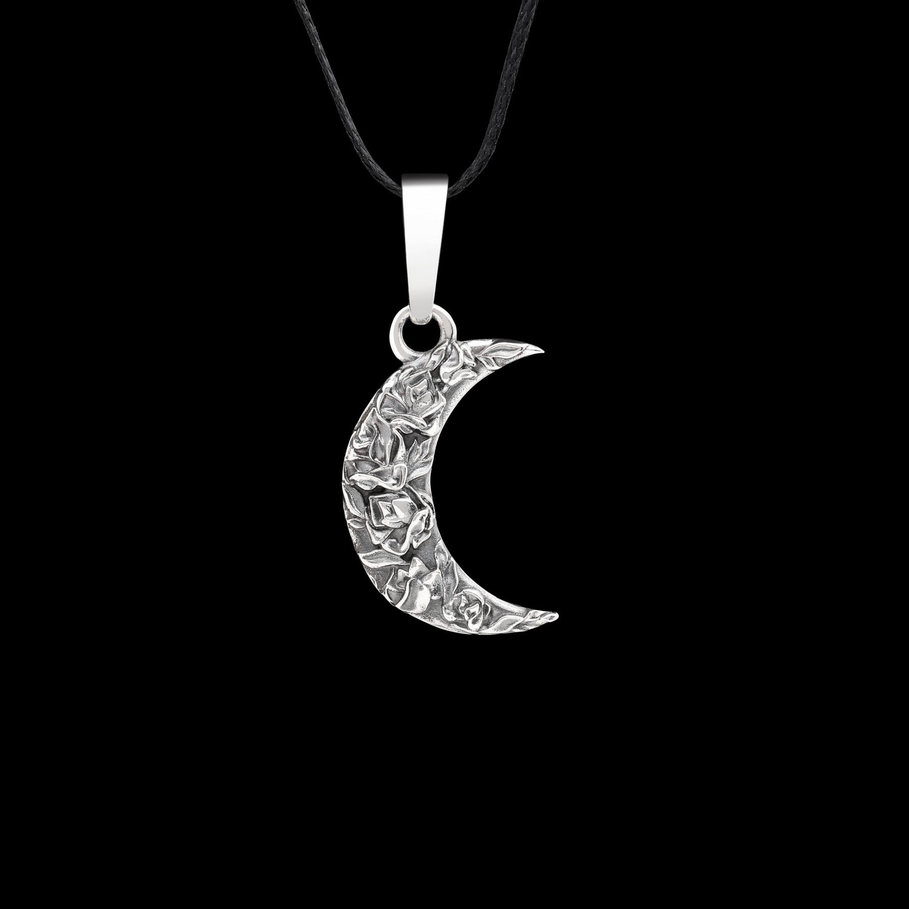 Sterling silver Moonlit Rose pendant with crescent moon and delicate rose design on black background.