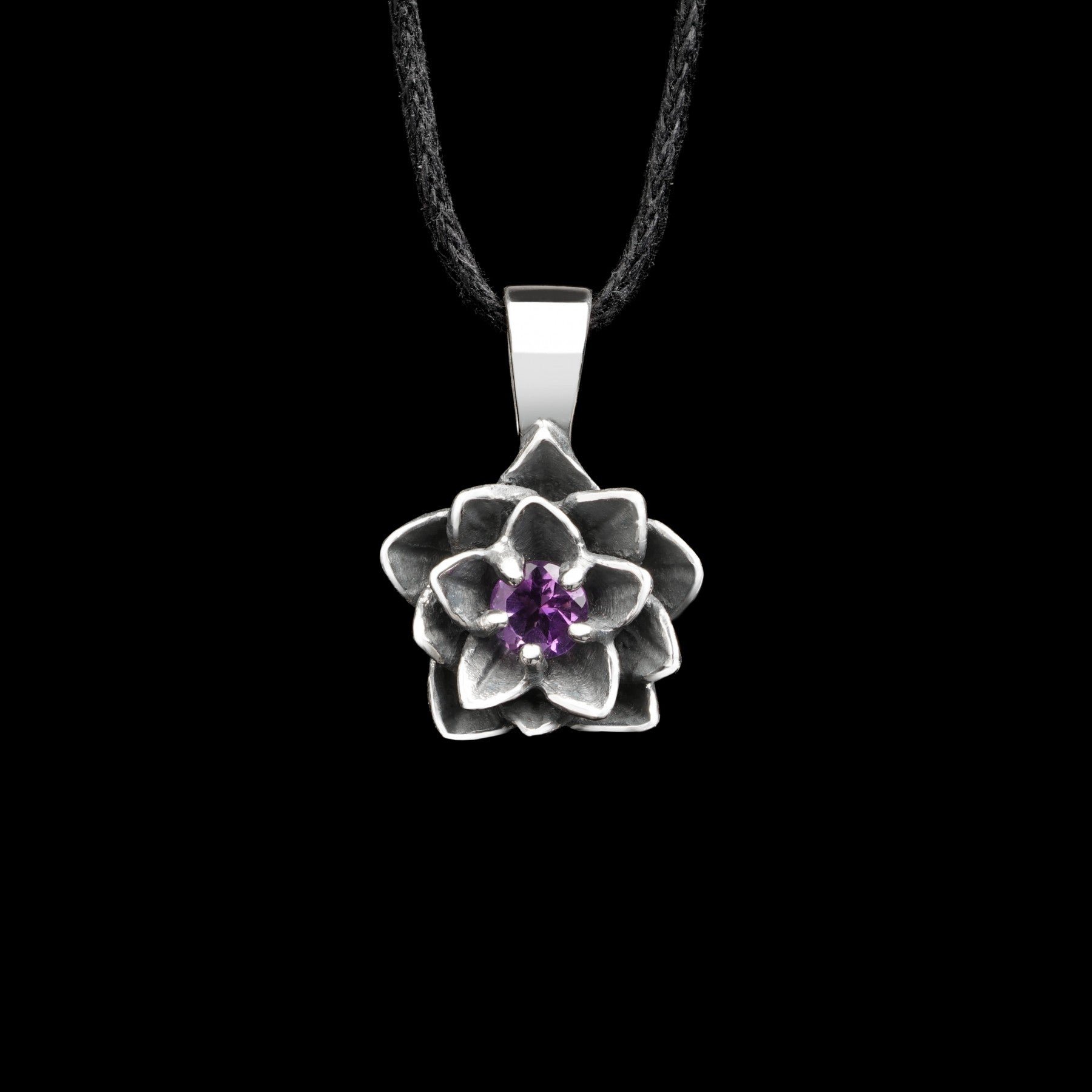 Sterling silver lotus flower pendant with amethyst stone, "Blooming Heart" design, symbolizing love and balance.