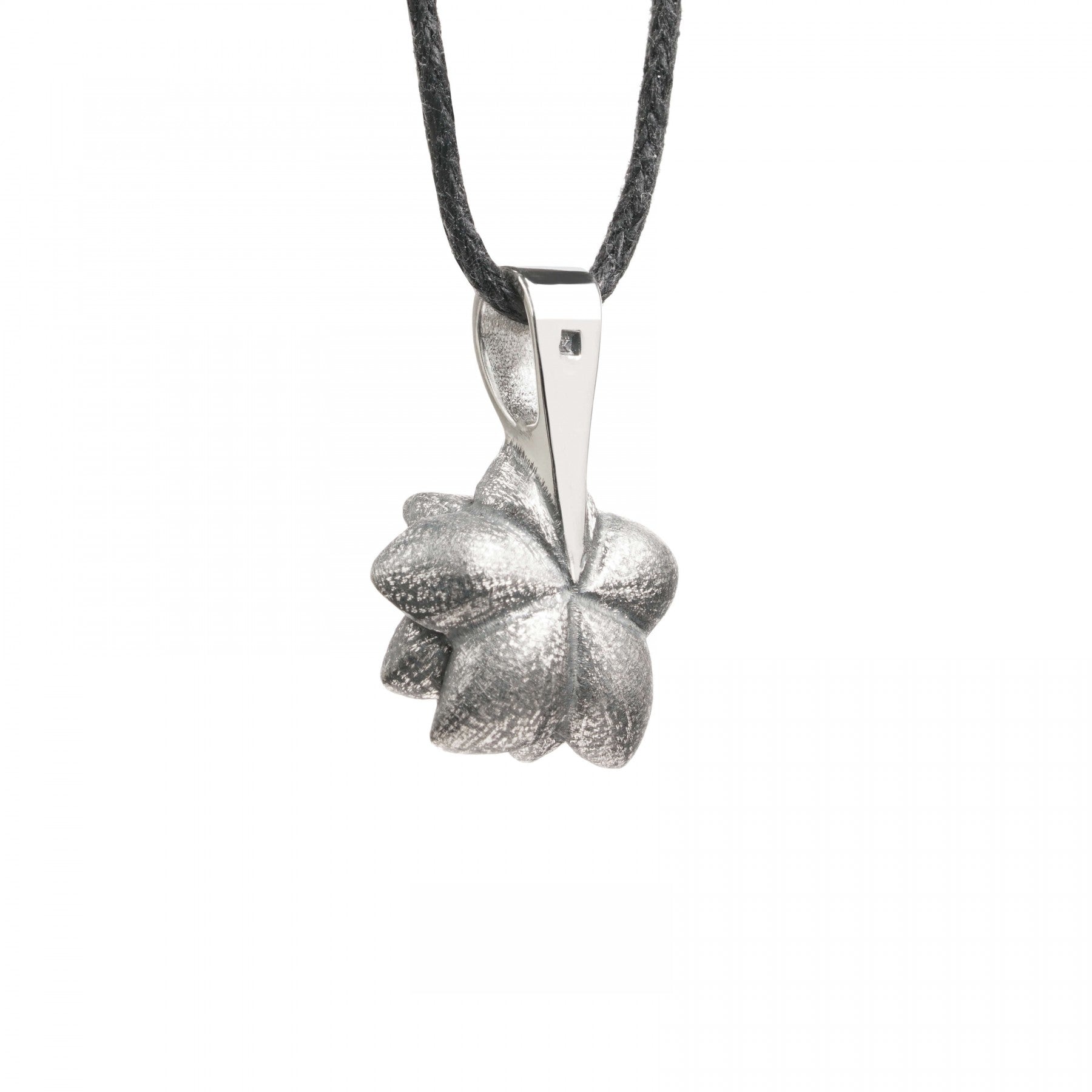 Sterling silver flower-shaped pendant with oxidized finish on a black cord necklace.