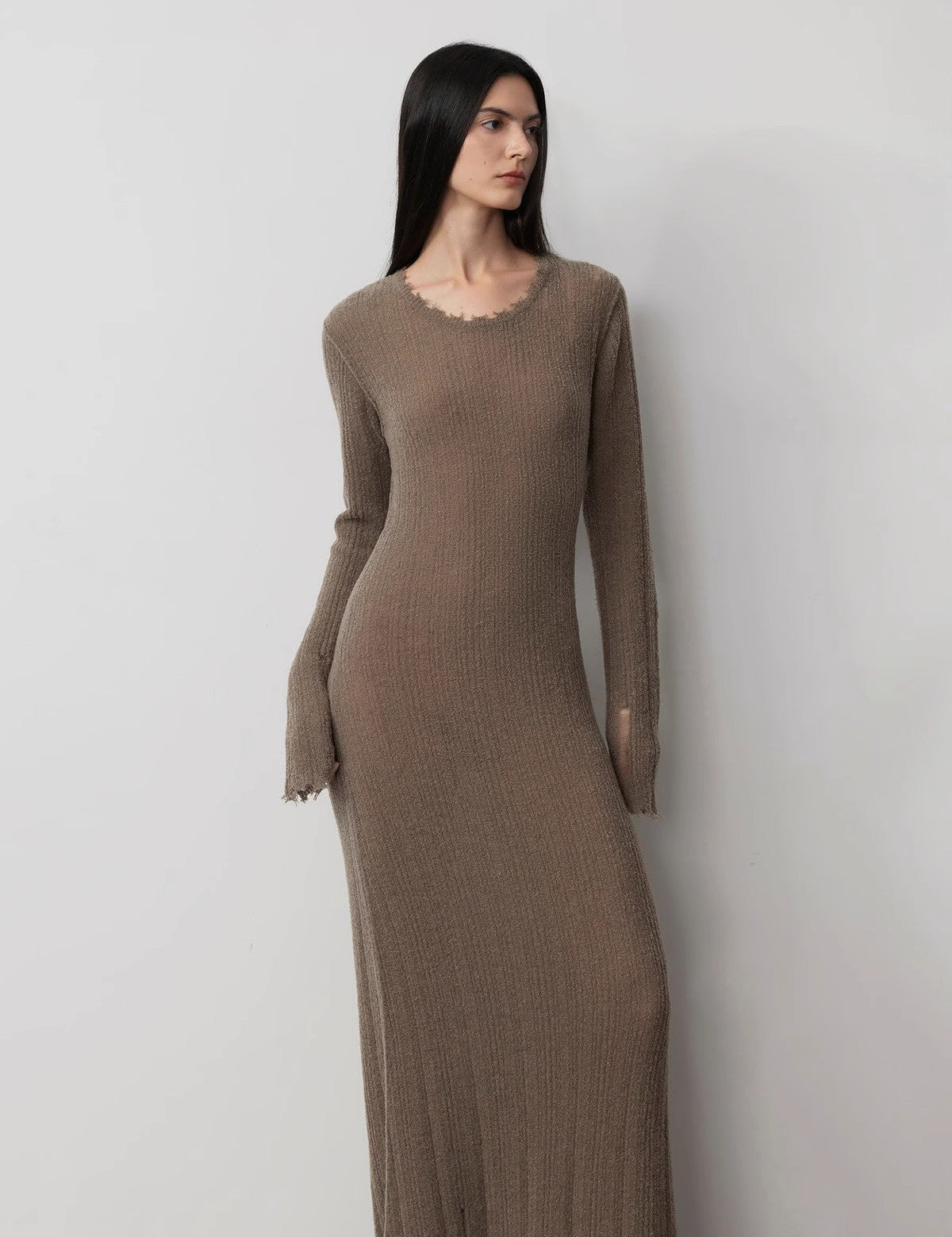 Fray Line Wool Knit Dress with frayed edges and subtle cut-outs, featuring a round neckline and slim-fit design for a contemporary look.