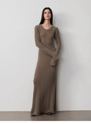 Model wearing Fray Line Wool Knit Dress with frayed edges and cut-outs, showcasing edgy sculptural knit fashion on a minimalist backdrop.